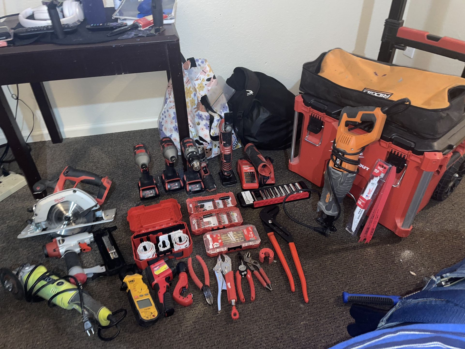 Milwaukee pack out game box full of Milwaukee tools, power and hand to
