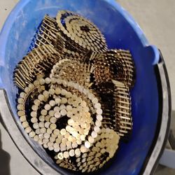 Bucket Of Roofing Nail Rolls For A Nail Gun