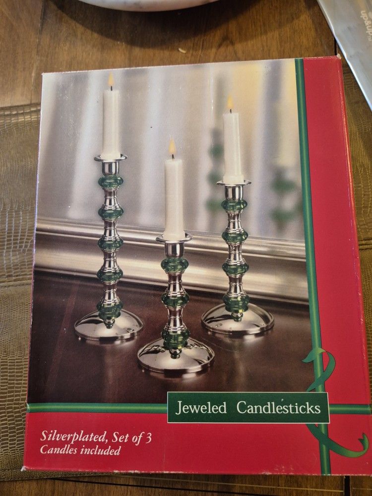 Brand new in original box set of three silver plated candlesticks