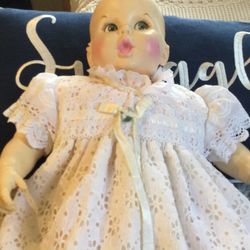 I’m Not Sure How Old This Doll Is But Her Eyes Move And She Squeaks When You Turn Her Over. Shes Plastic And Her Body Is Cloth.