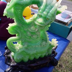 The green jade dragon statue in the image is a prominent symbol of wealth and prosperity in Chinese culture and Feng Shui practices. 
Dragon Symbolism