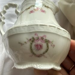 Vintage White Floral Pitcher. White porcelain pitcher with pink rose garland and scalloped rim. Some light wear to gold but no cracks or chips. 