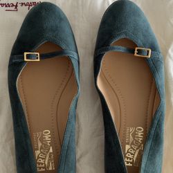 This is a pair of Salvatore Ferragamo Audrey suede ballet flats in a green/teal color with a gold-tone buckle strap