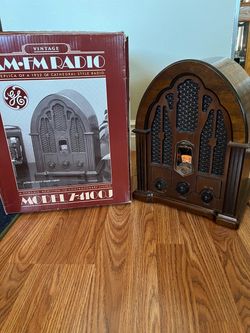 The General Electric (GE) Model 7-4100JA is a popular mid-1980s reproduction of a 1930s-style "cathedral" radio, often found with a wood veneer cabine