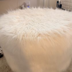 White fuzzy stool with gold legs