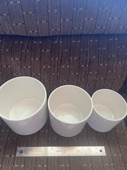Selling a matching set of 3 minimalist white ceramic cylinders in nesting sizes. Clean, sleek design that fits beautifully with modern, boho, or mid-c