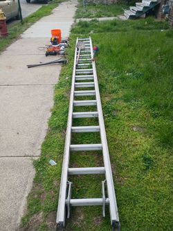 32 ft. Ladder with some tools on the side also comes with the motorized edger