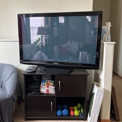Panasonic TV with Roku and TV stand.