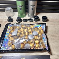 2 Portable Expresso Machines With 30 Volluto Decaffeinato Capsules