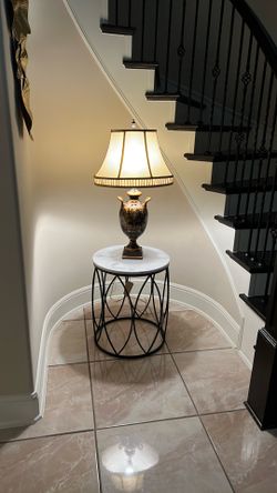 Table and lamp life is from the 50s table is black iron with marble top