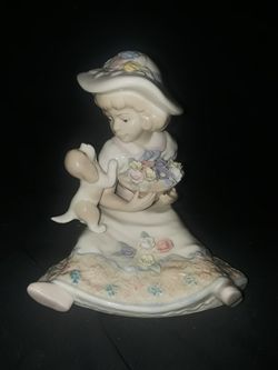 Porcelain figurine girl with flowers and dog