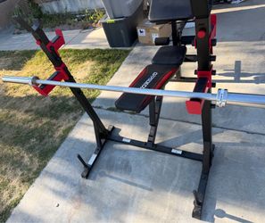 Very nice looking Olympic weight bench that can adjust to 6 positions and brand new 6 ft Olympic barbell