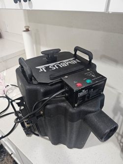 This is a Chauvet DJ Nimbus Jr dry ice machine, a compact model used for creating low-lying "fog on the ground" effects.