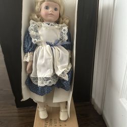 Likely: Dynasty Doll Collection Porcelain Doll