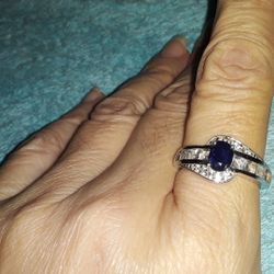 Dark Blue Sapphire ring with white topaz baguette accents.