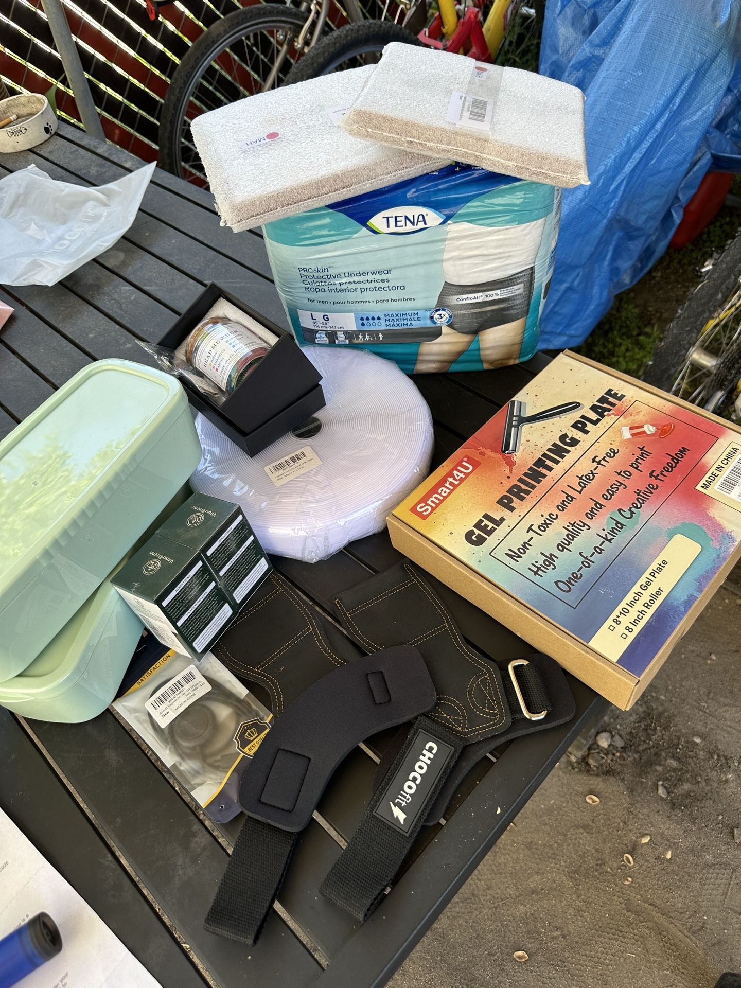1 lot of misc brand new stuff. weight lifting braces. 26 yards of velcro. USB device. vitamins. 2 containers. prayer jar. adult diapers etc