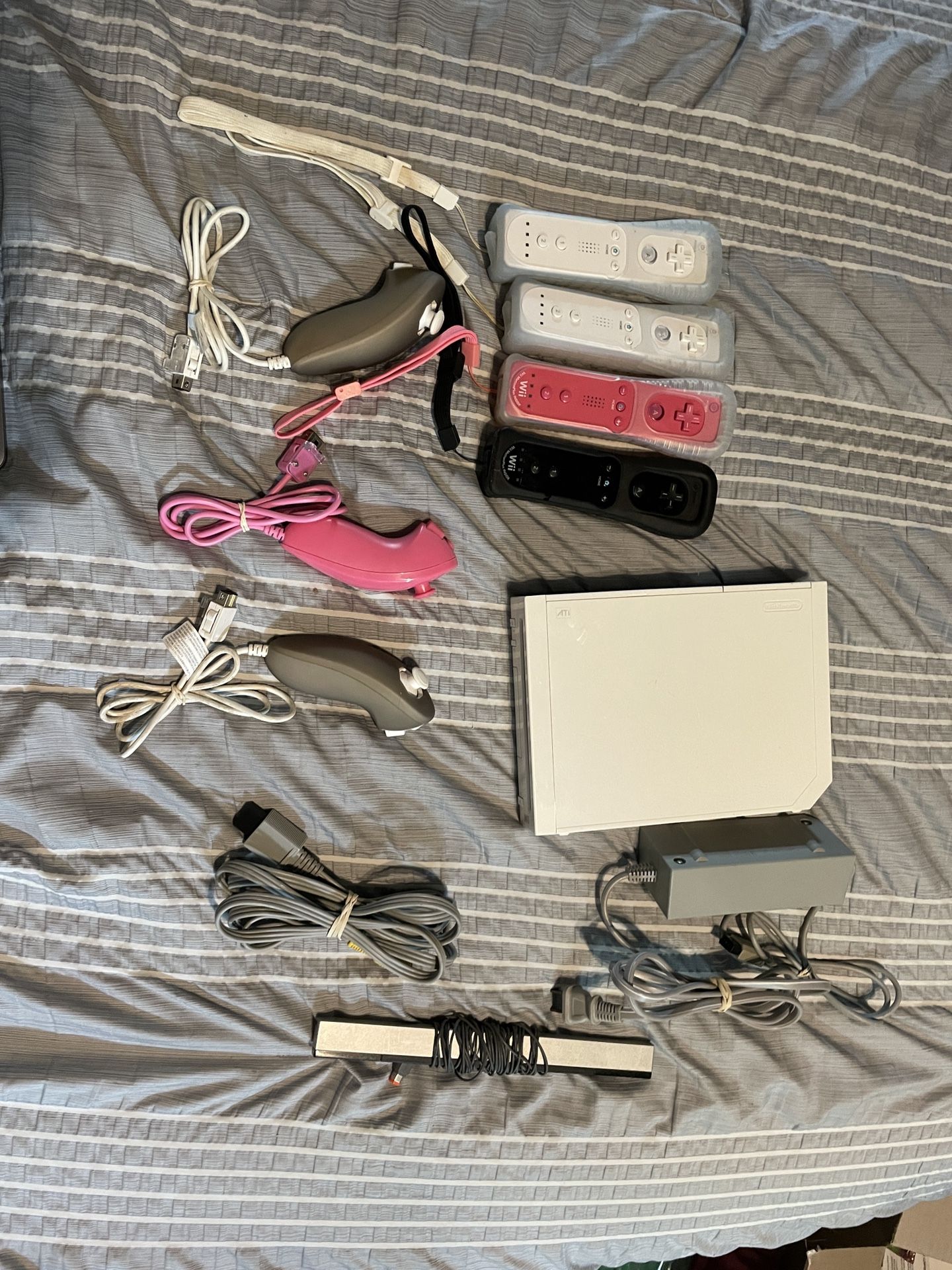 Nintendo Wii With Remotes, Nunchucks, And Games