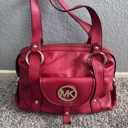 Michael Kors Fulton large pebbled leather shoulder bag in a red or fuchsia color. 