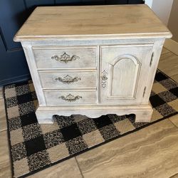 Side table with three drawers and a door for storage