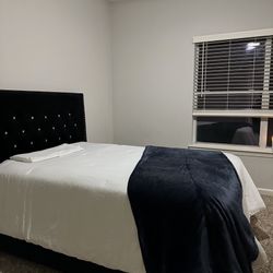 Full sized bed with frame and mattress.