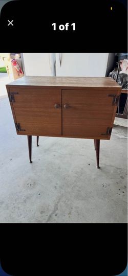 Vintage wooden cabinet with distinctive exposed metal straps hinges and 2 cabinet doors 33”Hx32”Lx16”W