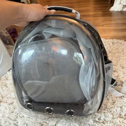 Clear Transparent Pet Backpack with Ventilation pet backpack with breathable mesh sides. Ideal for small pets. Features ventilation holes for comfort.