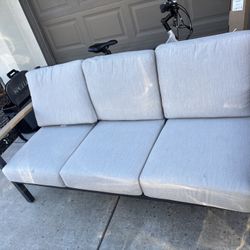 Outdoor patio furniture, two chairs, sofa, and a table