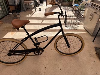 Pure City cruiser bike — tan tires, front basket, comfy saddle. Rides smooth. Great for cruising