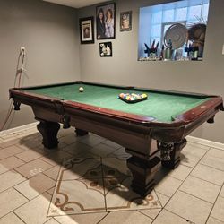 Pool table, plus sticks and stick wall mount