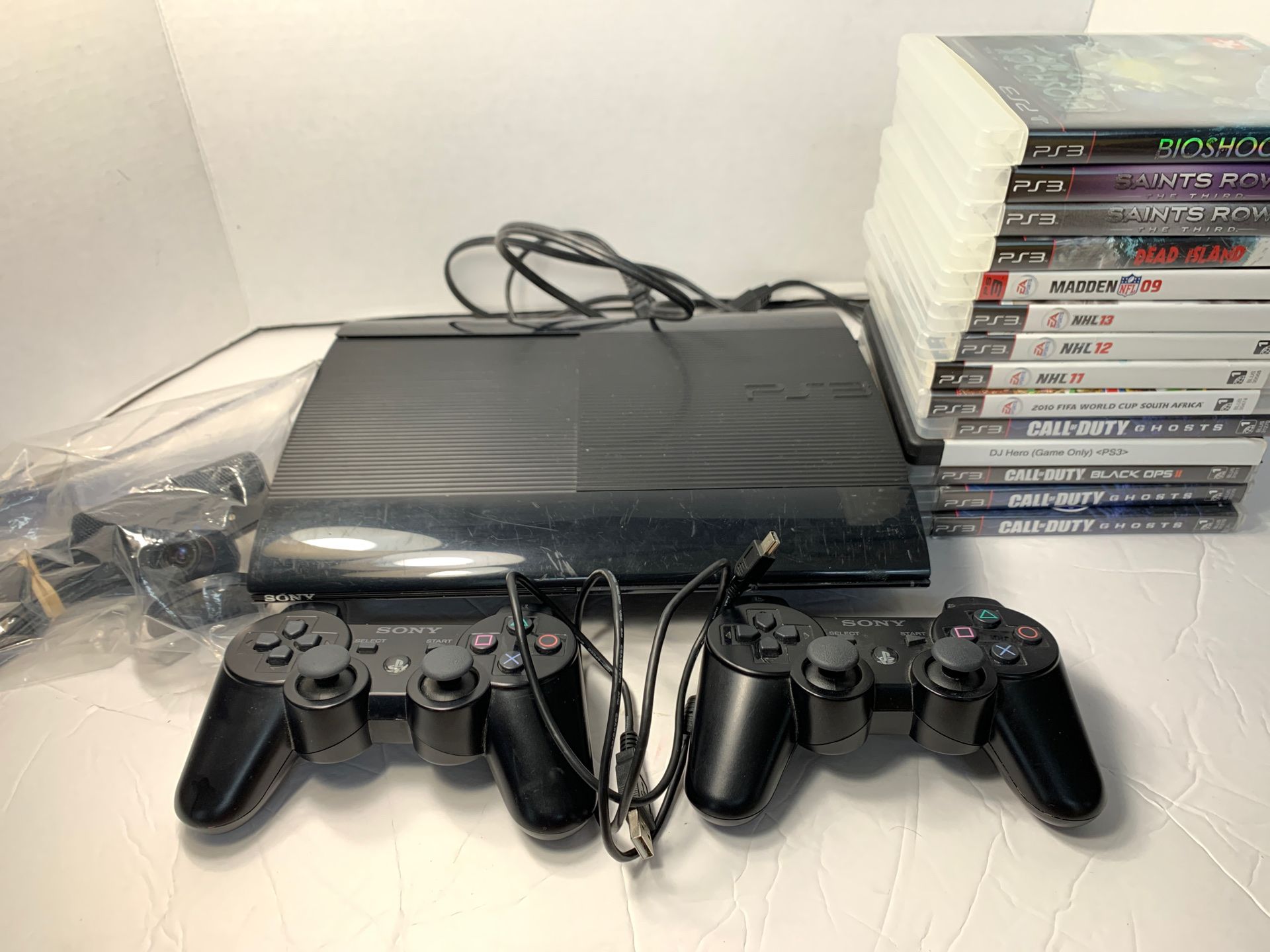 PS3 super slim 250gb console 1 camera 2 controllers 14 games and remote