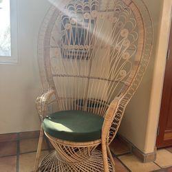Balinese peacock chair with green cushion