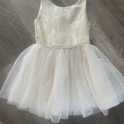 Girls size 4 dress cream and gold colored flower top  Big tulle skirt  Buttons up on back with a bow Good condition  Make offer!!