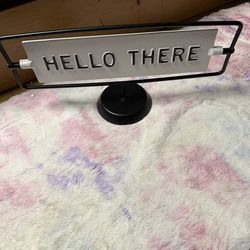 This product is a Hearth & Hand with Magnolia reversible metal tabletop sign, which features "Miss You Already" on one side and "Hello There" on the o