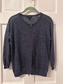 Lightweight zip-up cardigan is 55% linen and 45% polyester. Heathered dark gray/blue knit sweater has long sleeves and ribbed cuffs. Size XXS from J.C