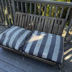 Outside wooden bench seat with cushions