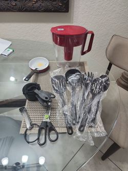 6- black new Cooking Utensils, new egg pan and spatula, measuring cups teaspoons and scissors & a Brita water pitcher , and broom dustpan and plunger