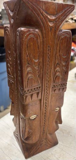 hand-carved wooden four-faced totem,Papua New Guinea