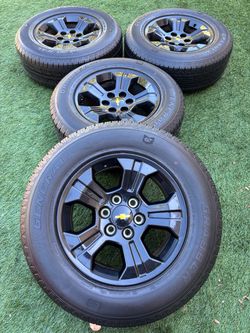 Chevy Silverado new tires and black OEM rims