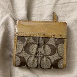brown and tan coach wallet 