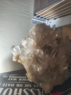 A large clear quartz cluster featuring numerous crystal points growing