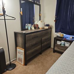 Brown wooden dresser with attached mirror