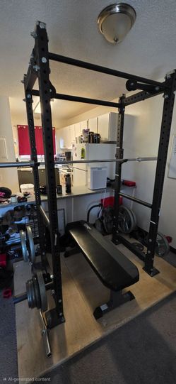 Titan t3 power rack with 300 pound Olympic weight set and extra 25 pound curl bar