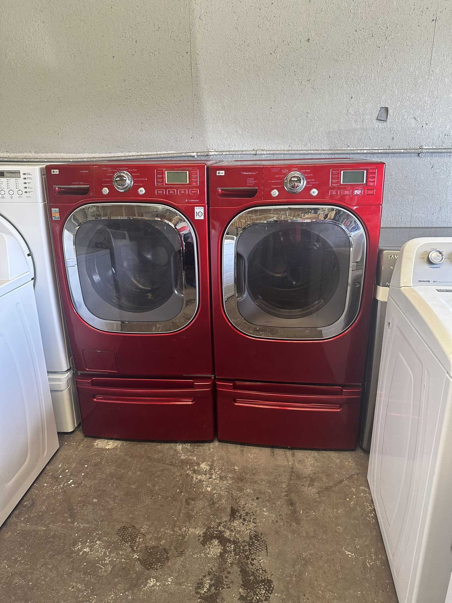 Red front load, LG washer and gas dryer on pedestals can deliver 