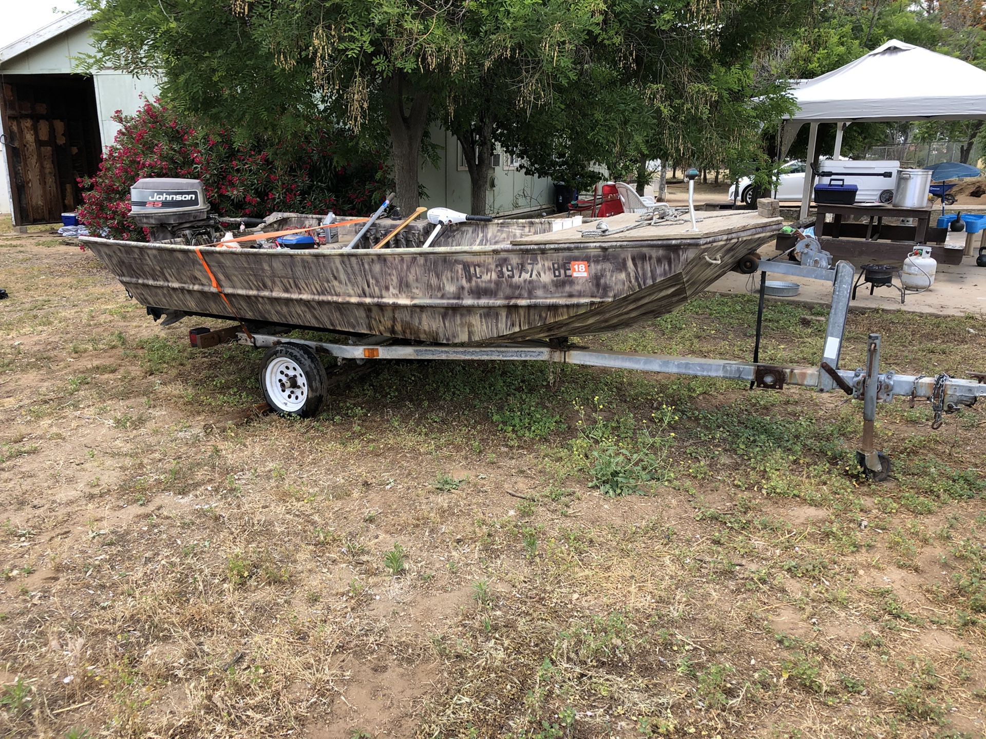 14’ Jon Boat / camouflage/ with 25 Johnson and trolling motor.