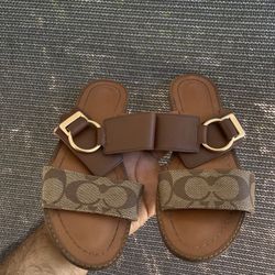 Coach Hallie slide sandals in signature coated canvas and leather. 