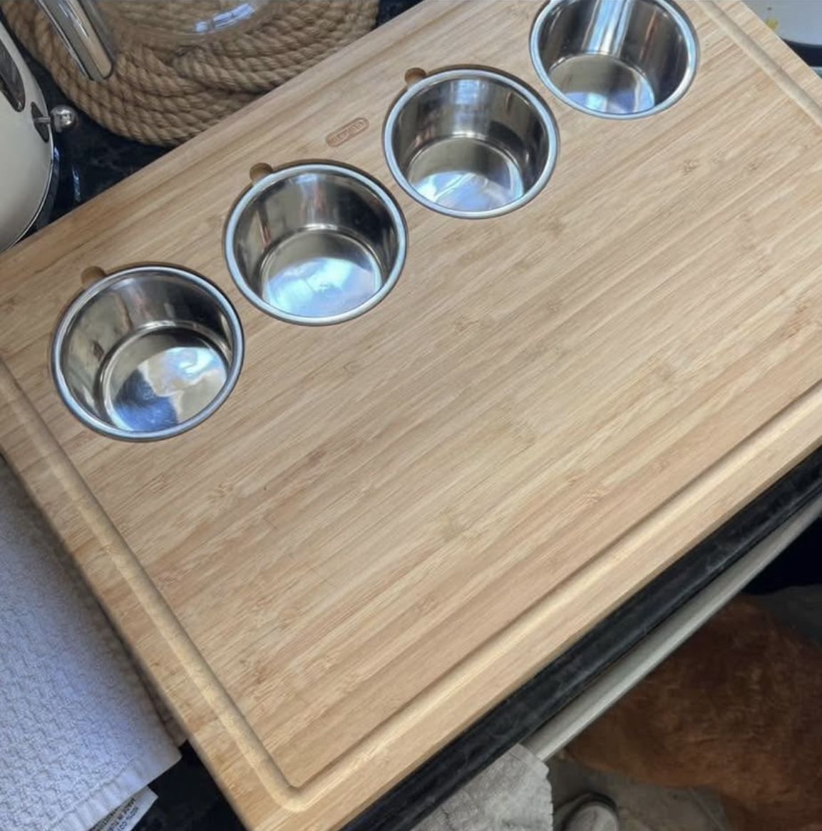 Bamboo cutting board with three stainless steel bowls. 13x19 inches