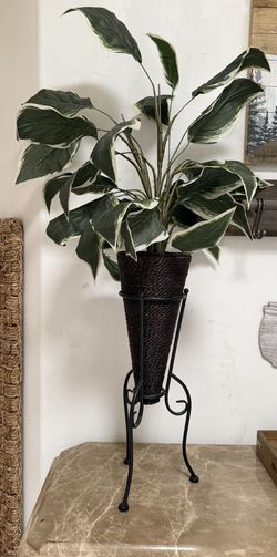 2 artificial plants in wicker baskets
