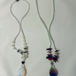 Set of 2 handmade necklaces in white and green tones with decorative pendants.