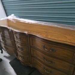 wooden chest of drawers with its dressing table