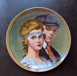This Edwin M. Knowles collector's plate, titled "Meeting On The Path," features a gold-rimmed design from the Norman Rockwell Rediscovered Women colle
